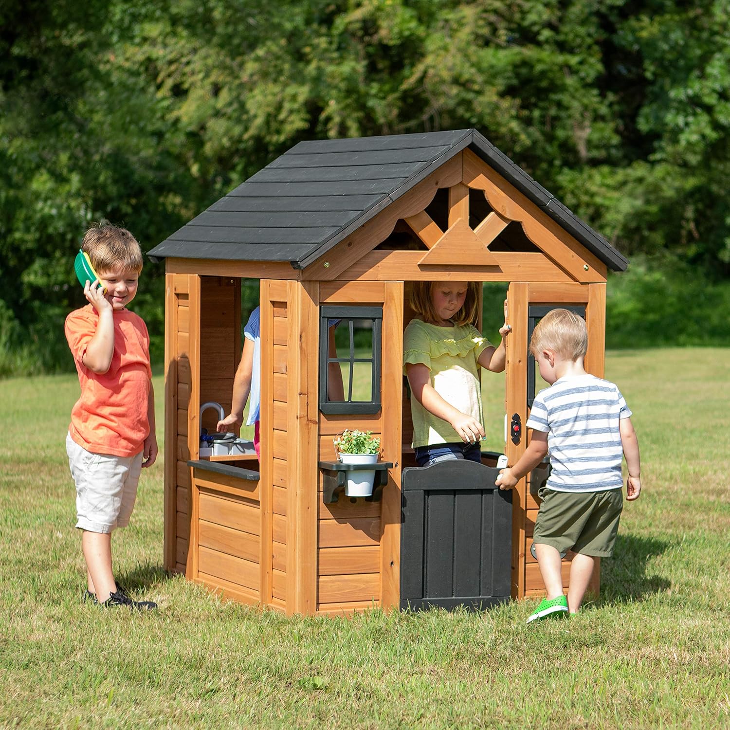 Children's playhouse cabin, equipped with a game kitchen, snack bar, half-door, toy phone, windows, flower pot stand and an operable doorbell, suitable for creative outdoor games.(Light Brown)